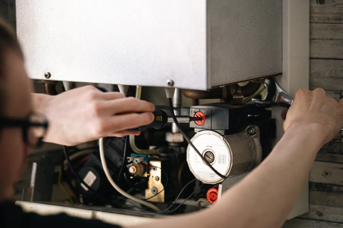 Pro-Tech technician servicing a high-efficiency boiler system of the kind common in Heritage Hill's historic Grand Rapids homes